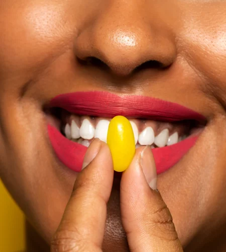 person-holding-jelly-bean-candy-their-mouth